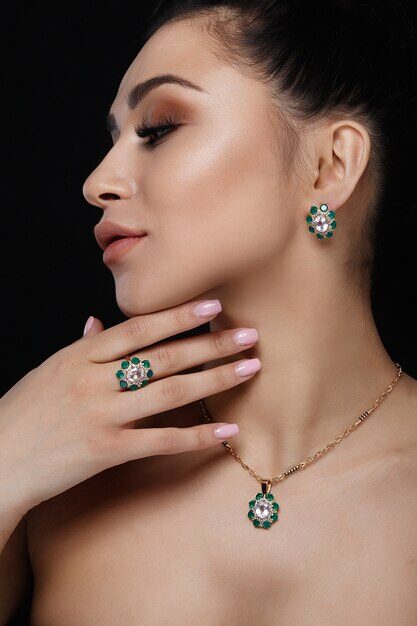 charming-model-with-dark-hair-shows-rich-golden-earrings-necklace-ring_8353-5040-5206765